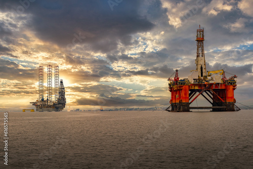 2023-06-04 MOTH BALLED OIL PLATFORMS DOCKED IN THE BAY NEAR CROMARTY SCOTLAND WITH A BEAUTIFUL CLOUDY SKY photo