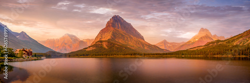 Panorama View of Sunrise over Swiftcurrent Lake and Grinnell Point in Glacier National Park in Montana, USA photo