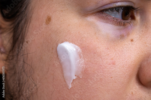 white moisturizer on a woman's face 