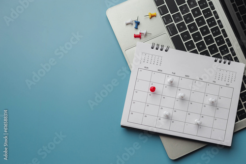 Obraz na plátne Embroidered red pins on a calendar event Planner calendar,clock to set timetable organize schedule,planning for business meeting or travel planning concept