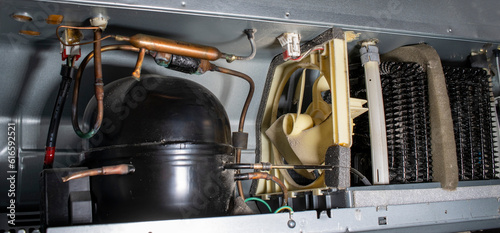 Fridge compressor or condenser,  Faulty Refrigerator with corroded copper pipes, and dusty coils, electrical wiring.  Regular maintainence and repair of kitchen appliances. 