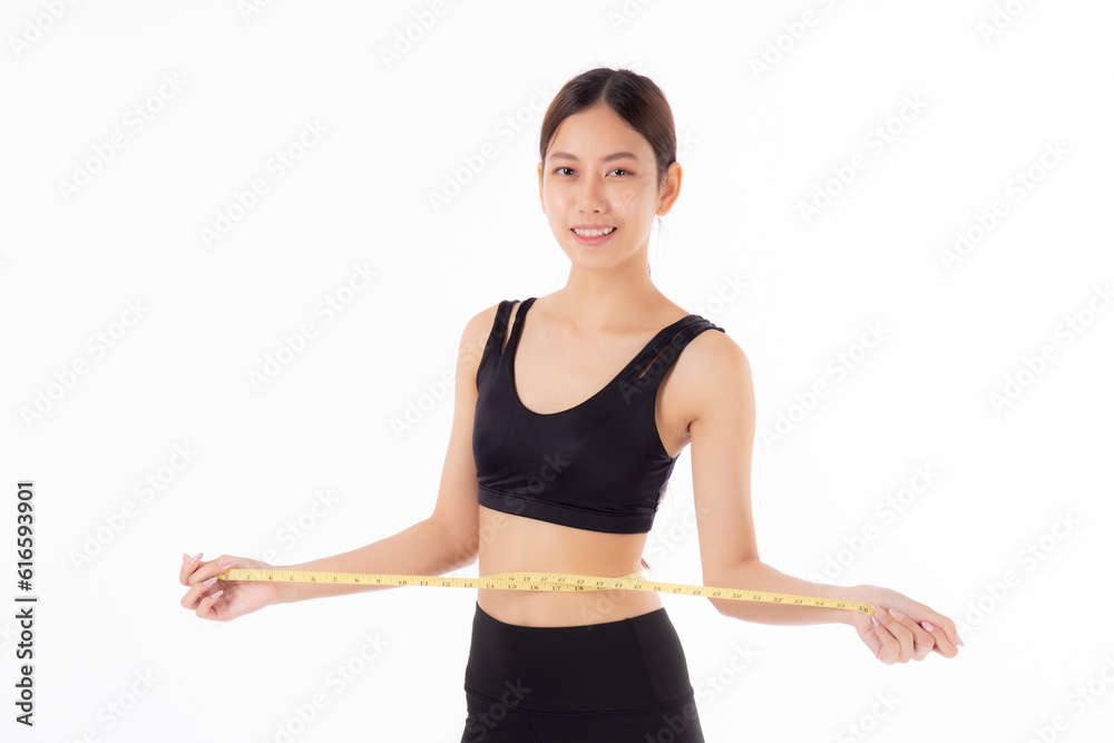 Portrait beautiful young asian woman measure tape with waist for weightloss with satisfied isolated white background, female in sportswear slimming shape with workout, sport and health care concept. Portrait beautiful young asian woman measure tape with waist for weightloss with satisfied isolated white background, female in sportswear slimming shape with workout, sport and health care concept.