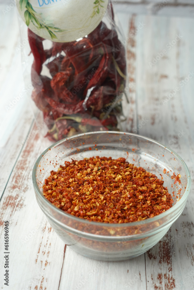 top view of chili flakes in a bowl on table top view of chili flakes in a bowl on table