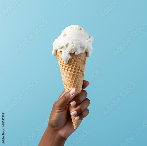 Ice cream cone on a blue background. The woman holding the ice cream by hand. Made with genertaive ai photo