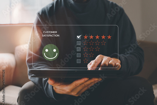 customer service evaluation and feedback rating. costumer review concept, man using phone chooses happy smiling face