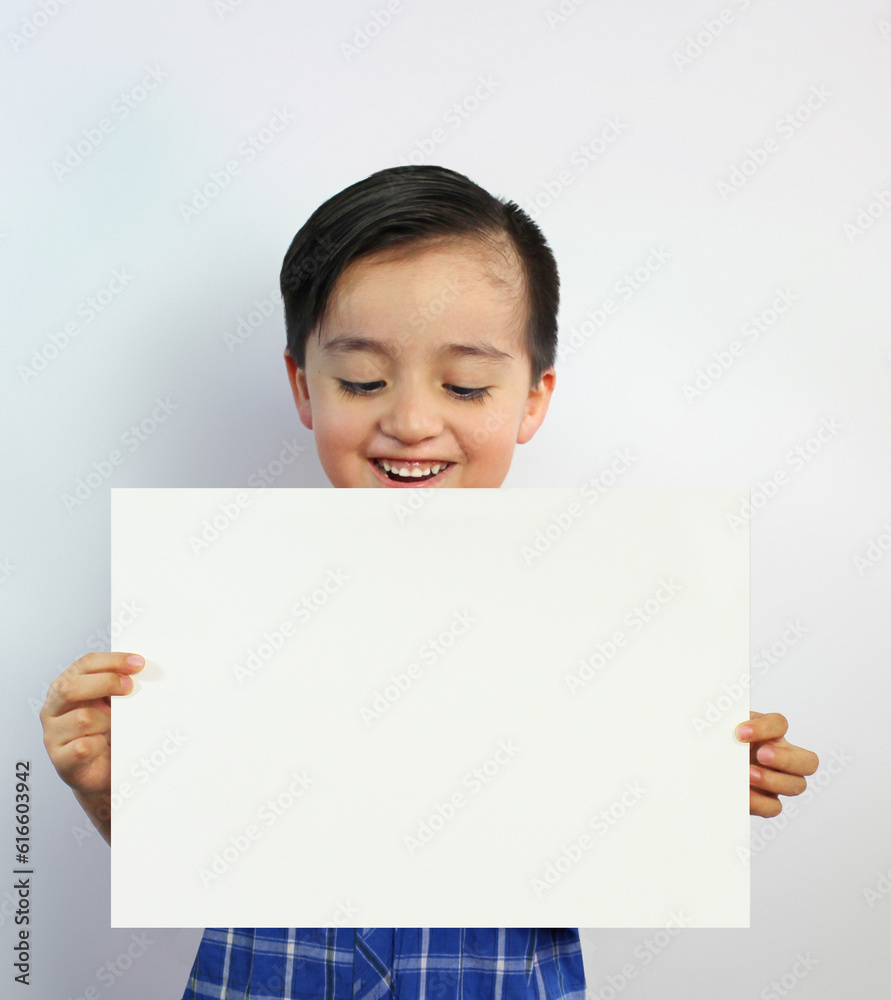 child showing a white piece of paper, smiling and looking at the paper, holding the blank sheet of paper in his hands, on white background child showing a white piece of paper, smiling and looking at the paper, holding the blank sheet of paper in his hands, on white background