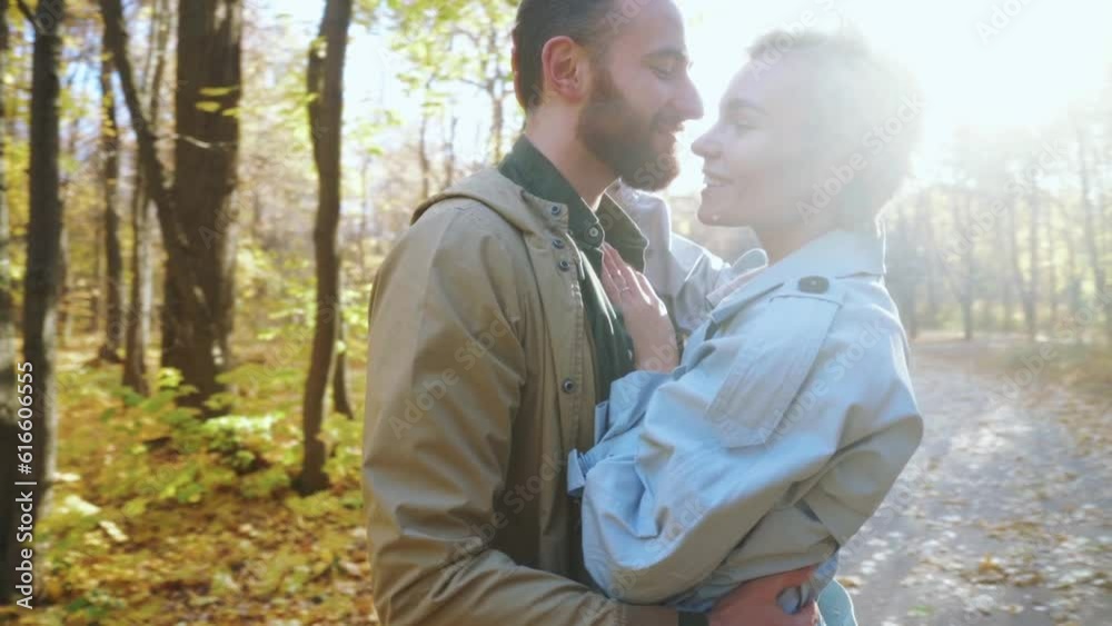 Romantic handsome man hugging happy blonde woman couple has fun park Happiness tenderness Loving couple laughing enjoy weekend on autumn nature on warm sunny day