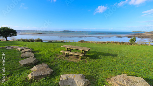 View from park with brunch table of a sand beach during low tide a winter sunny afternoon, Lancieux, Brittany, north of France