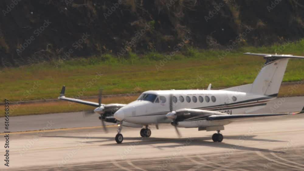 Private owner taxiing at Phuket airport, medium shot side view. Business jet on the runway or taxiway. Tourism and travel concept Private owner taxiing at Phuket airport, medium shot side view. Business jet on the runway or taxiway. Tourism and travel concept