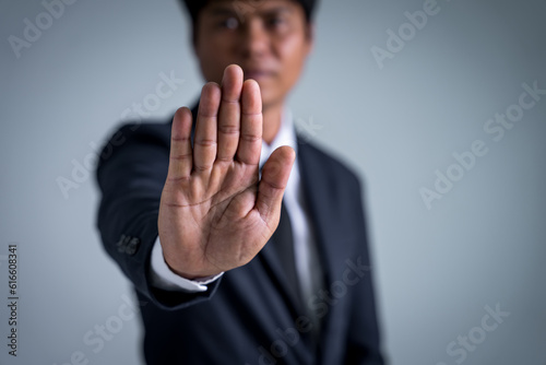 Businessman with raised hands as a stop, demanding bribes for business benefits, offenses in public and private organizations must be prosecuted by law. Being arrested for breaking the law.