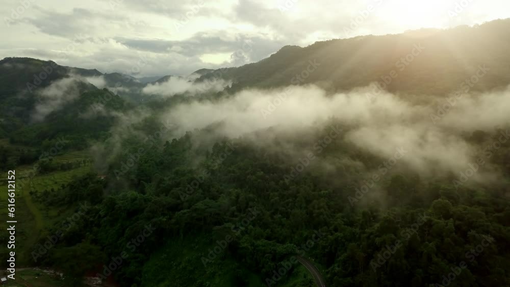 Aerial view flying above lush green tropical rain forest mountain with rain cloud cover during the rainy season on the Doi Phuka Mountain reserved national park the northern Thailand Aerial view flying above lush green tropical rain forest mountain with rain cloud cover during the rainy season on the Doi Phuka Mountain reserved national park the northern Thailand
