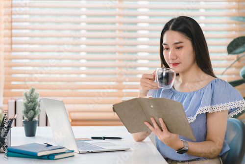 A businesswoman from a millennial startup is depicted working with financial report paperwork in her home office, highlighting the concepts of financial advising, teamwork, and accounting.