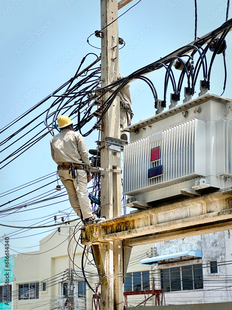 Low Angle View of an Unrecognizable Electrician Working Near the High Voltage Transformer