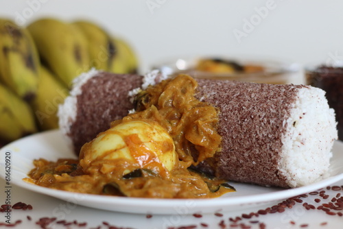 Poongar rice puttu served with spicy egg curry and bananas