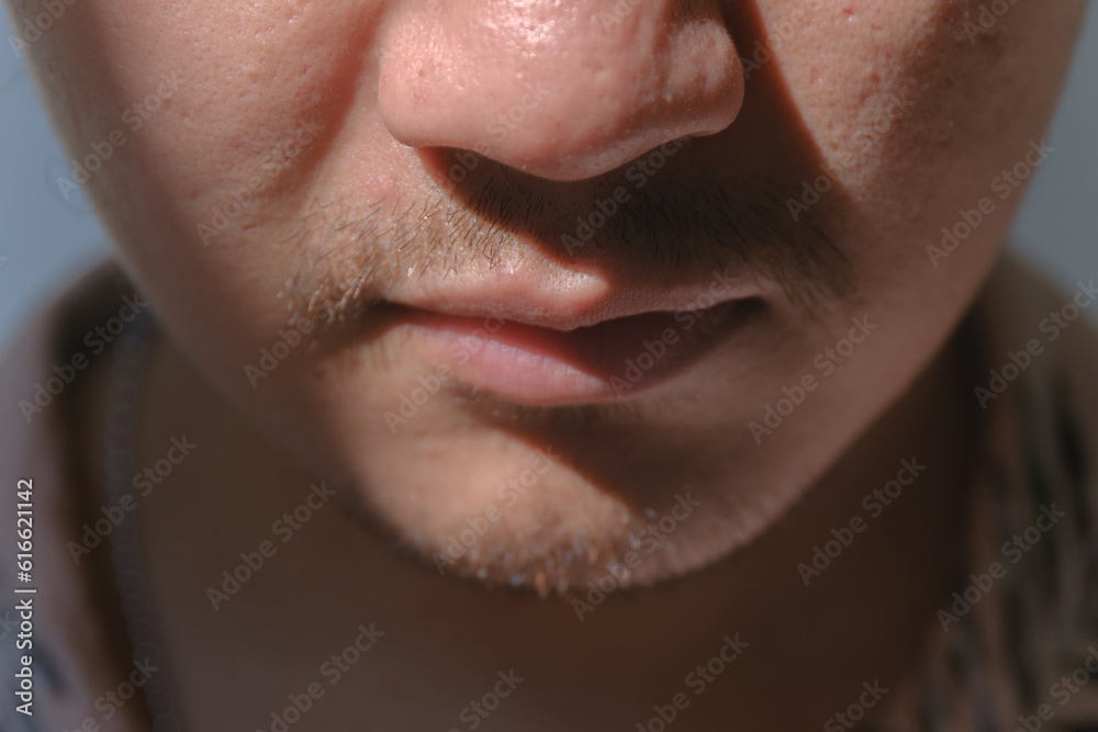 Close-up and soft focus shot of a man's partial face with a little mustache and beard. Bokeh or blurred background. Close-up and soft focus shot of a man's partial face with a little mustache and beard. Bokeh or blurred background.