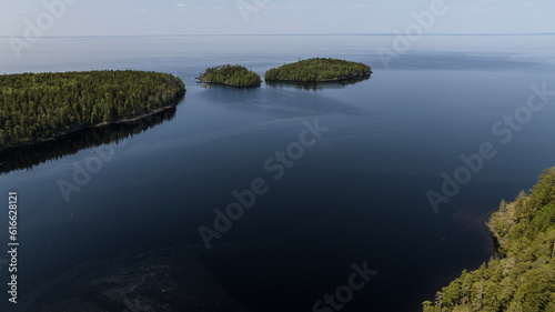 panoramic view of the Valaam skerries and monasteries against the backdrop of blue water and a sunny day