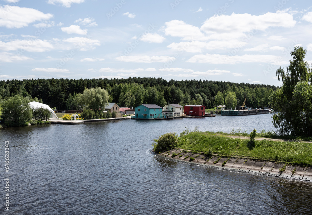 rural landscape from the ship with houses and technological buildings on a sunny day