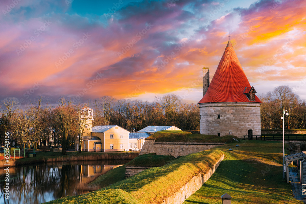 Kuressaare, Saaremaa, Estonia. Cannon Tower On Territory Of Episcopal Castle In Sunset. Traditional Medieval Architecture, Famous Attraction Landmark. Amazing Magic Cloudy Sky Above Cannon Tower.
