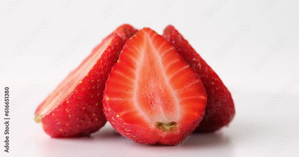 Slices of fresh strawberries rotating in circle on white background. Delicious fresh strawberries Slices of fresh strawberries rotating in circle on white background. Delicious fresh strawberries