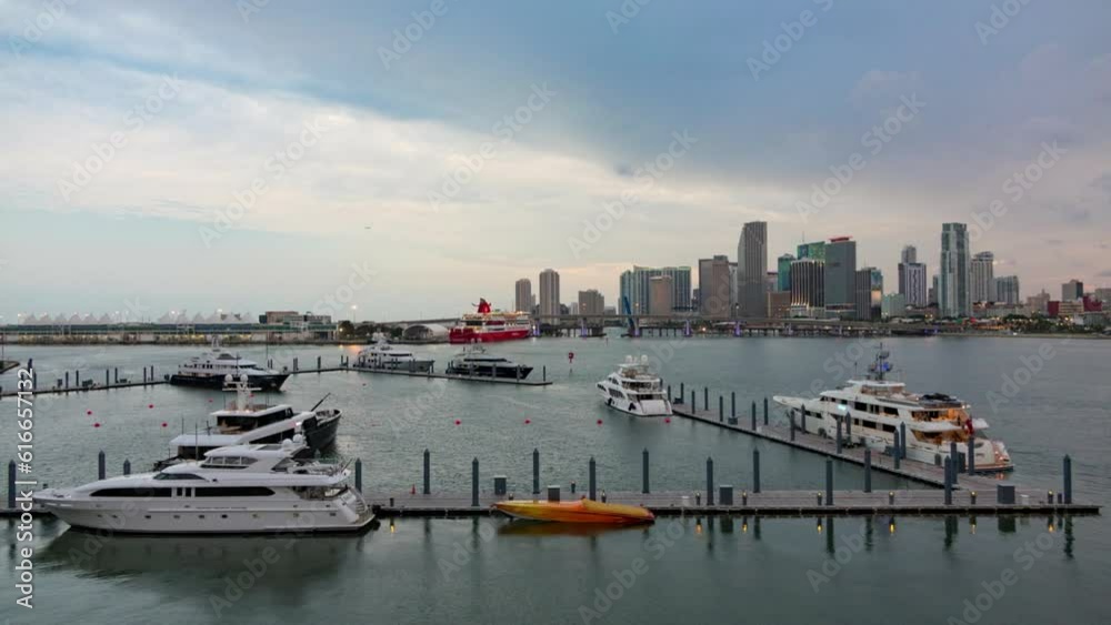 Lockdown Time Lapse Shot Of Yachts Moored At Harbor Near Buildings In City Against Cloudy Sky - Miami, Florida Lockdown Time Lapse Shot Of Yachts Moored At Harbor Near Buildings In City Against Cloudy Sky - Miami, Florida