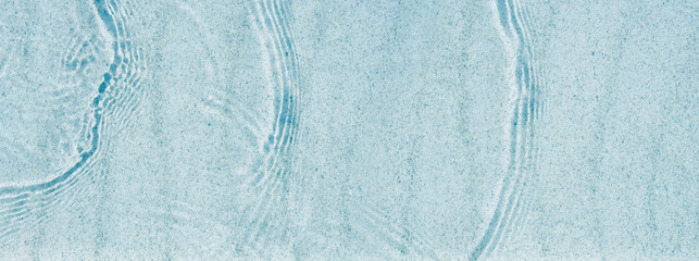 abstract white sand beach with transparent water wave from above, background concept banner for summer vacation holidays with space for text or product presentation