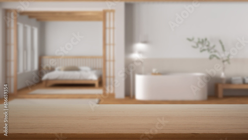 Empty wooden table, desk or shelf with blurred view of bathroom and bedroom in minimal style. Bed and freestanding bathtub, modern interior design concept