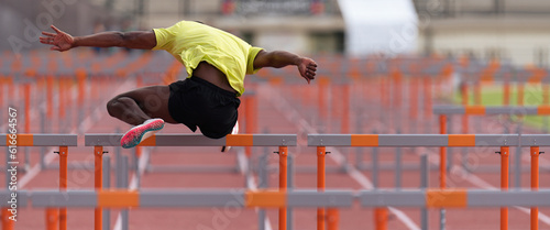 Fotografía A hurdle runner leaping over the hurdles, man is jumping over the hurdle