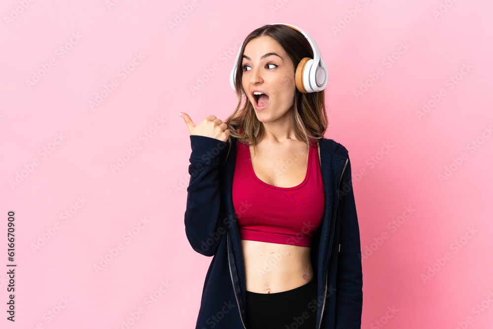 Young Romanian sport woman isolated on pink background intending to realizes the solution while lifting a finger up Young Romanian sport woman isolated on pink background intending to realizes the solution while lifting a finger up