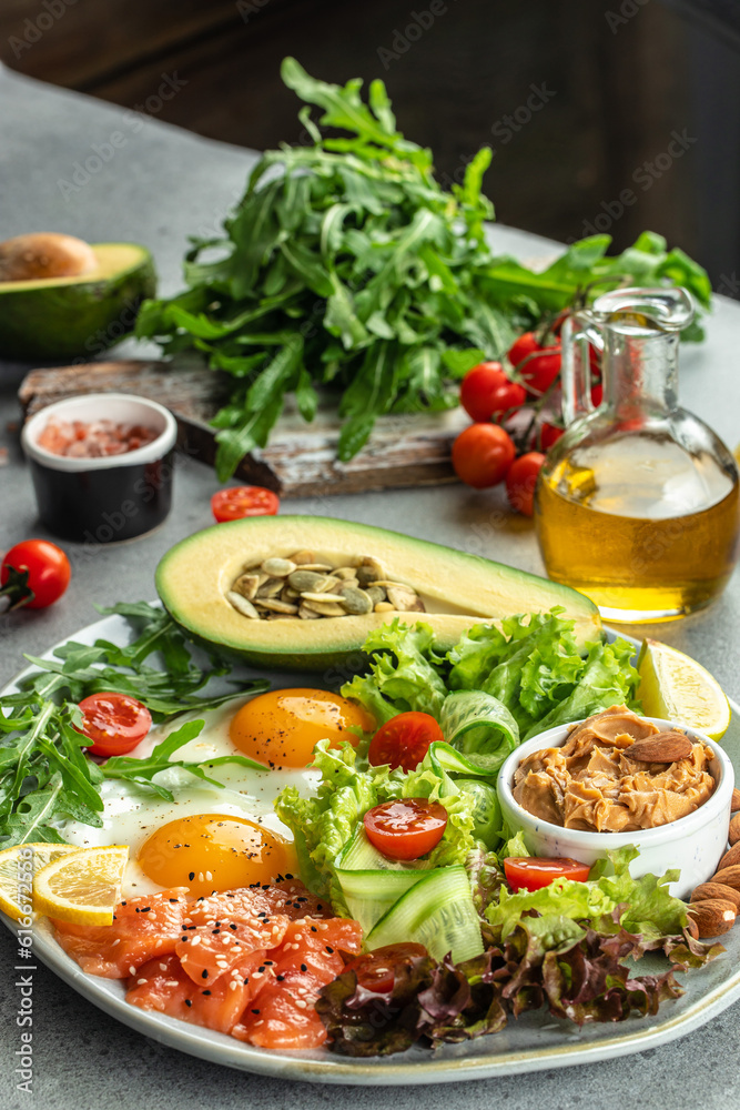 Healthy eating food vegetables salad, avocado, fish, eggs, nuts peanut paste. low carb keto ketogenic diet