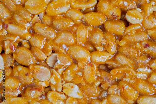 Caramelized nuts fried in honey - Gozinaki - orange granola peanut bar - close up, top view, macro. Traditional Georgian cuisine, oriental sweet, gastronomy and food concept photo