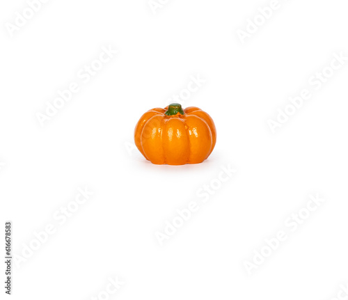 A small fake pumpkin isolated on a white background