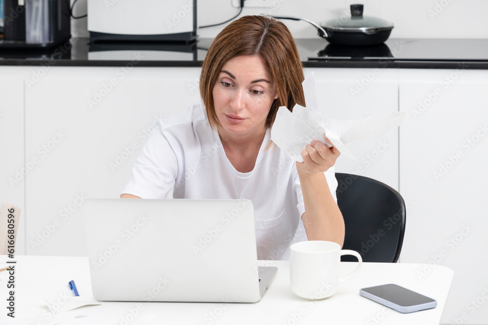 Close up of shocked woman sitting at the table, stressed and confused by calculate expense from invoice or bills, have no money to pay mortgage or loan. High prices and spending money concept Close up of shocked woman sitting at the table, stressed and confused by calculate expense from invoice or bills, have no money to pay mortgage or loan. High prices and spending money concept