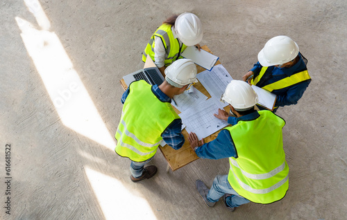 team of civil technician engineers discuss the timeline with architect foreman worker while inspecting, check safety infrastructure construction progress for sustainable green building at project site