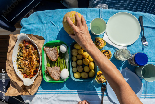 Photography Stockholm, Sweden A woman enjoys a summer picnic aboard a small motor boat in Lake Malaren  in the summer