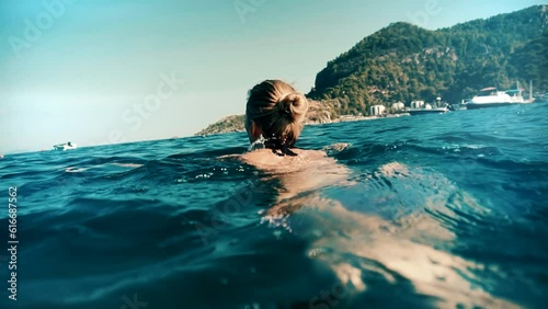 woman swimming underwater in sea in Kemer, Turkey photo