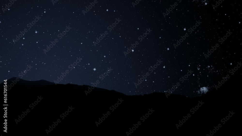 a movement of stars in the night sky with the view of mountains