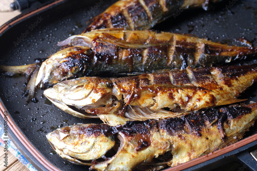 Teflon grilled skipjack. fish baked in a teflon-coated pan. Ikan cakalang bakar. Indonesian food.
Teflon grilled skipjack. fish baked in a teflon-coated pan. Ikan cakalang bakar. Indonesian food.