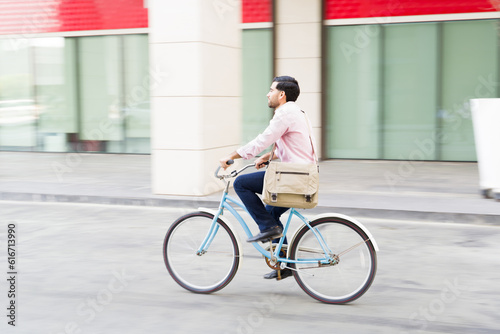 Young man on his commute to work using an eco friendly bicycle