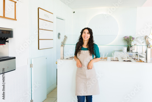 Portrait of a young woman working at the ice cream shop