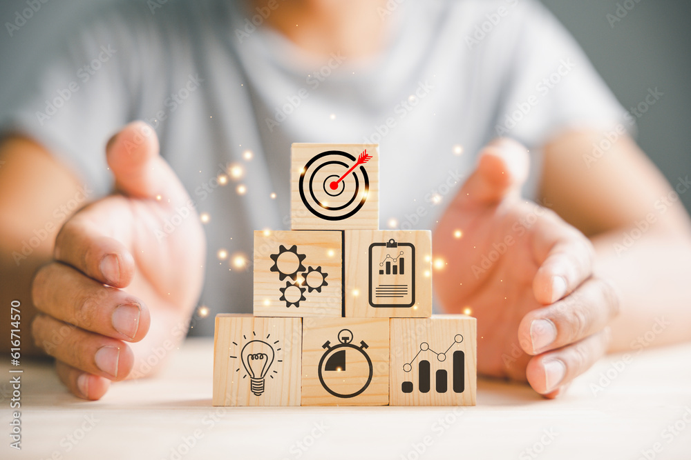 Obraz premium Hand arranging wood blocks in a step-by-step formation, symbolizing business strategy and Action plan. Copy space provided for professional presentations.