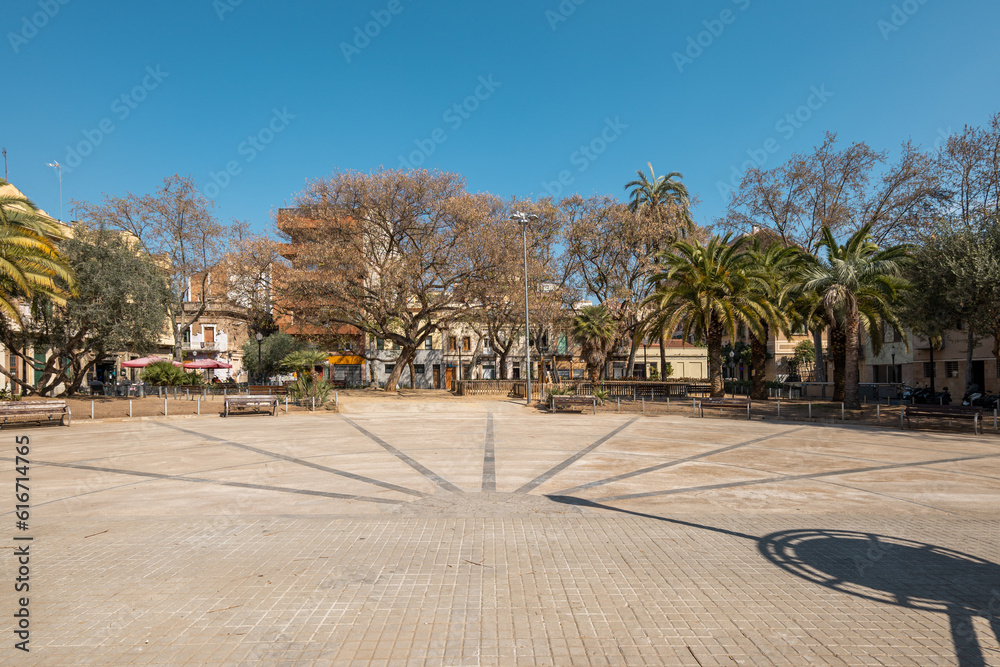 Residental square in barcelona with clear sky and tree-lined area