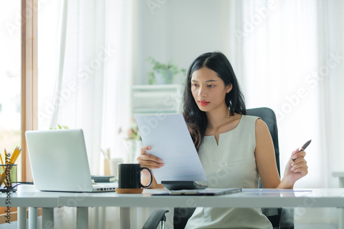 Free Download Professional female accountant working with financial statistics graphs at office desk.. - GFXLoad