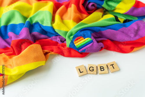 Rainbow flag of the LGBT community. Equal rights for all. The inscription near the flag in wooden letters.