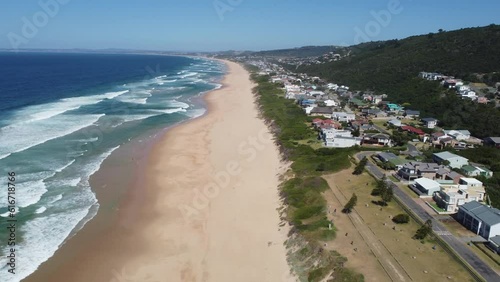 Aerial view of beach and ocean in Glentana, Mossel Bay, Western Cape, South Africa. Enjoy watching waves break onto the endless view of the golden sandy shore stretching from Glentana to Mossel Bay. photo