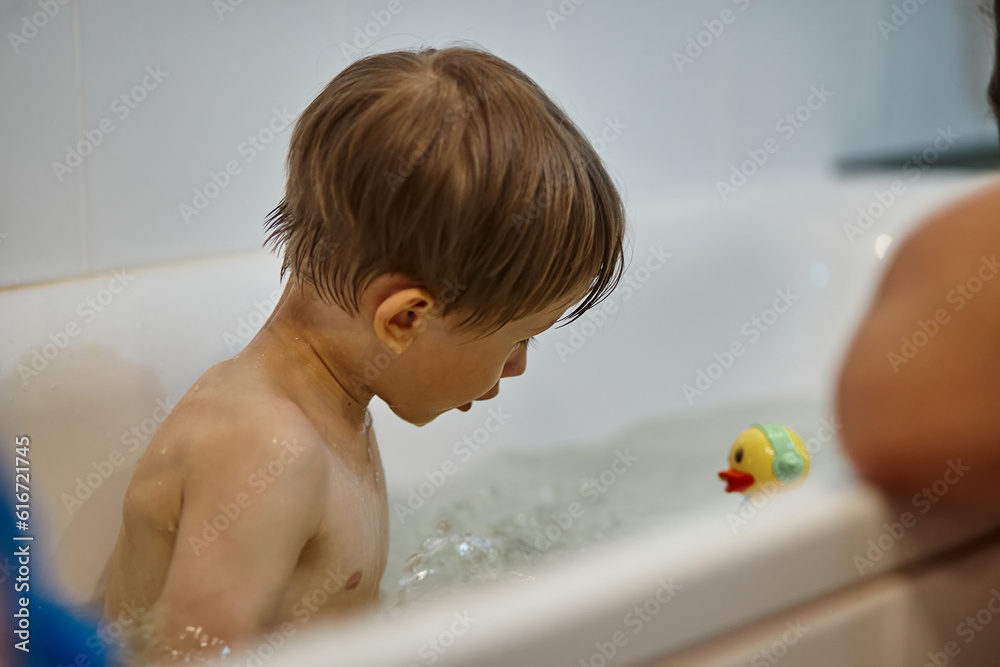 Father and child have fun in the bathroom while bathing son Father and child have fun in the bathroom while bathing son