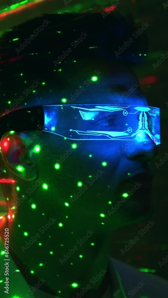 The man in interactive glasses on laser beam background. slow motion The man in interactive glasses on laser beam background. slow motion