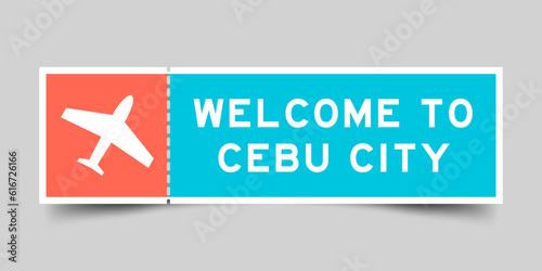 Orange and blue color ticket with plane icon and word welcome to cebu city on gray background photo