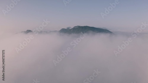 Drone video flying above the fog and clouds to the top of the fog beautiful scenery sea fog and high mountains