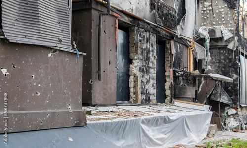 Residential buildings, windows and balconies were damaged by the blast and shrapnel from artillery shelling. The destruction of the city by military operations, the consequences of the war.