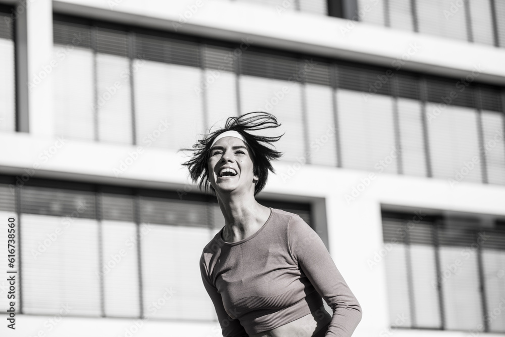 Fototapeta premium Black and white portrait of a young happy woman with a wide smile on her face